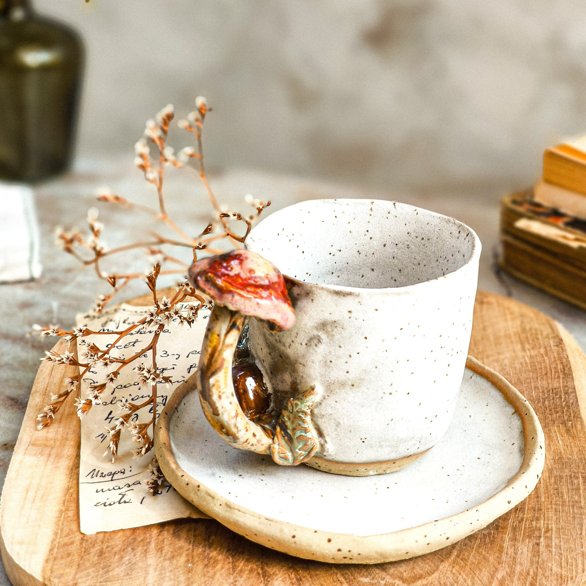 a driftwood white set of a cup with a mushroom handle and a saucer plate .
