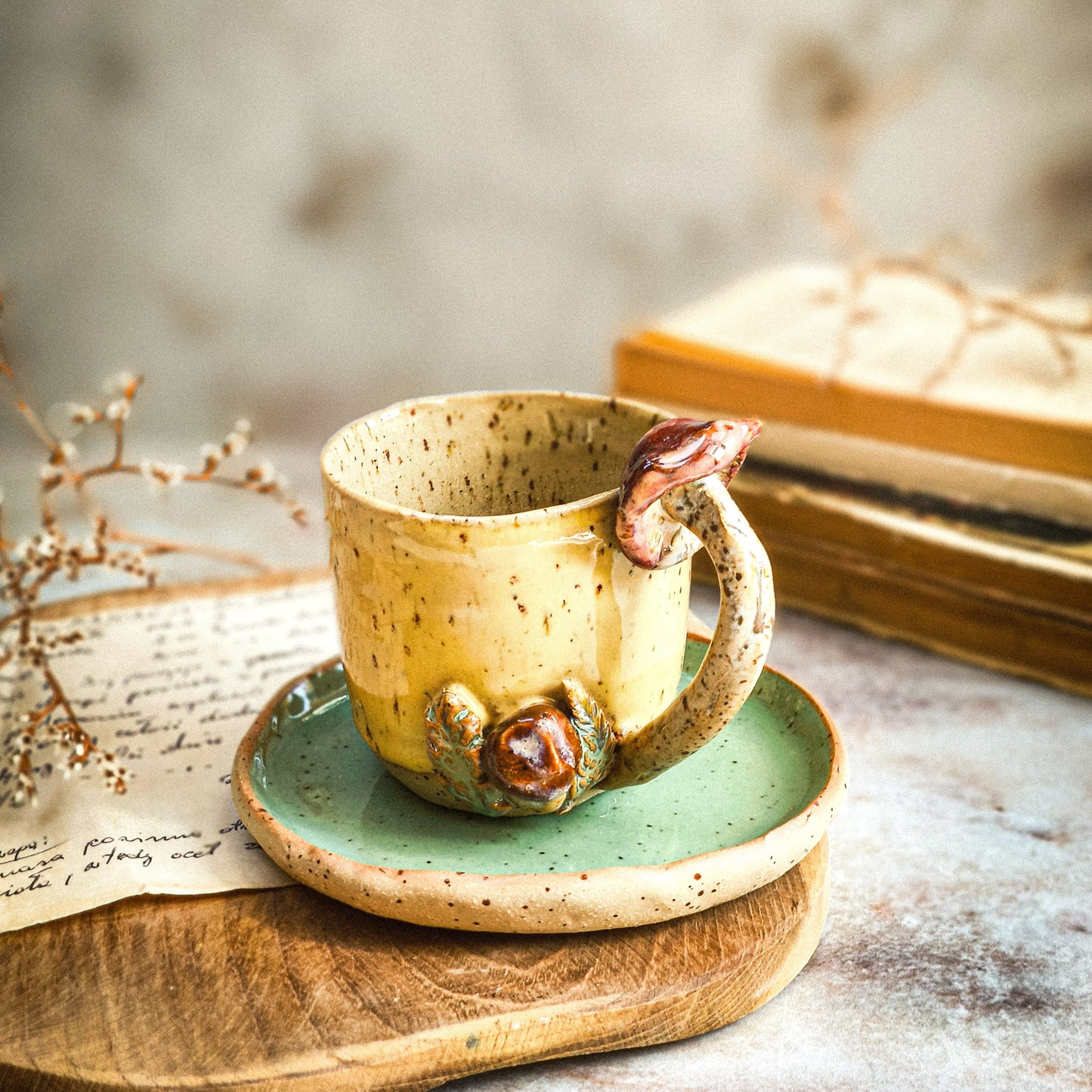 A handmade coffee or tea cup with mushroom handle in yellow .