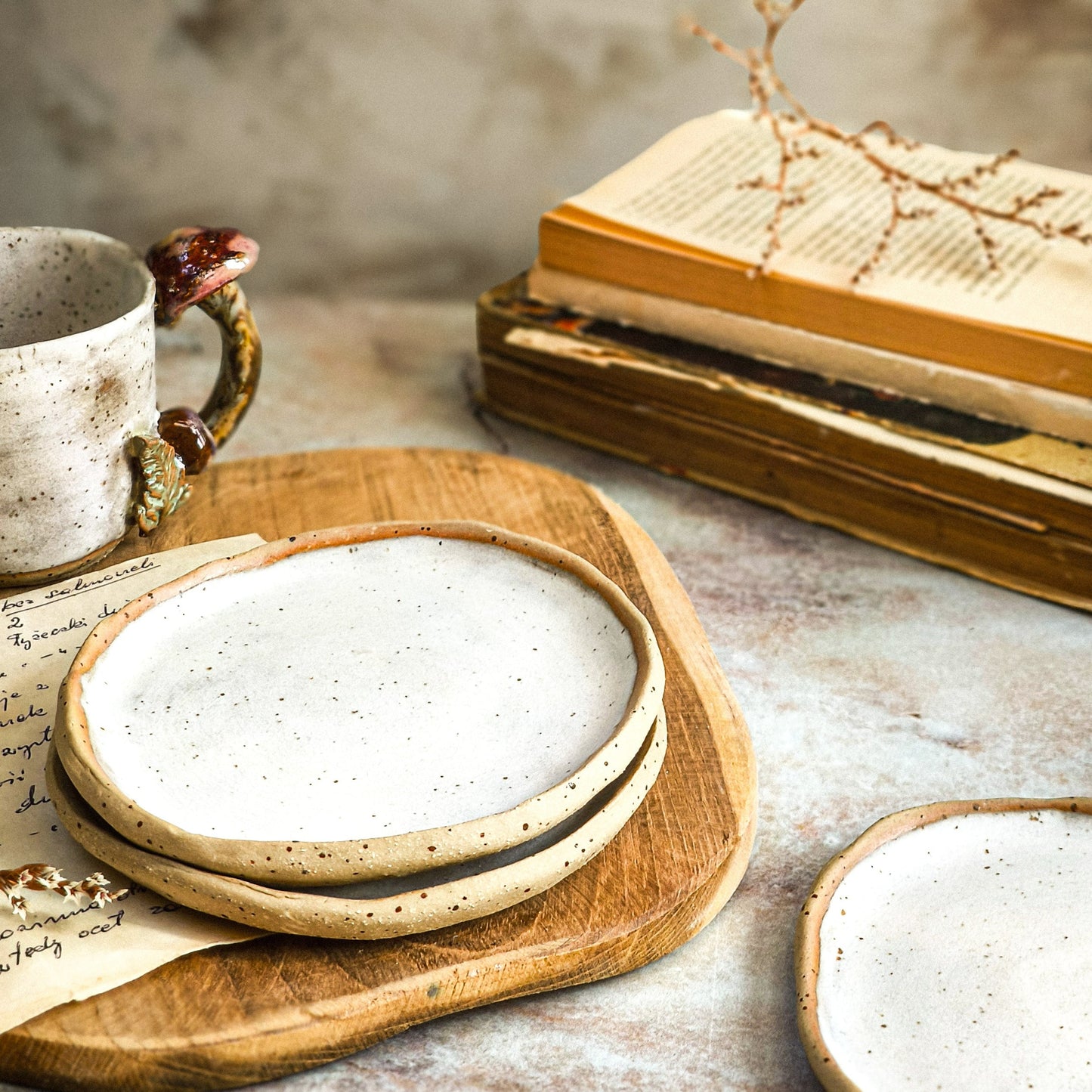 Handmade ceramic saucer plate in driftwood white .