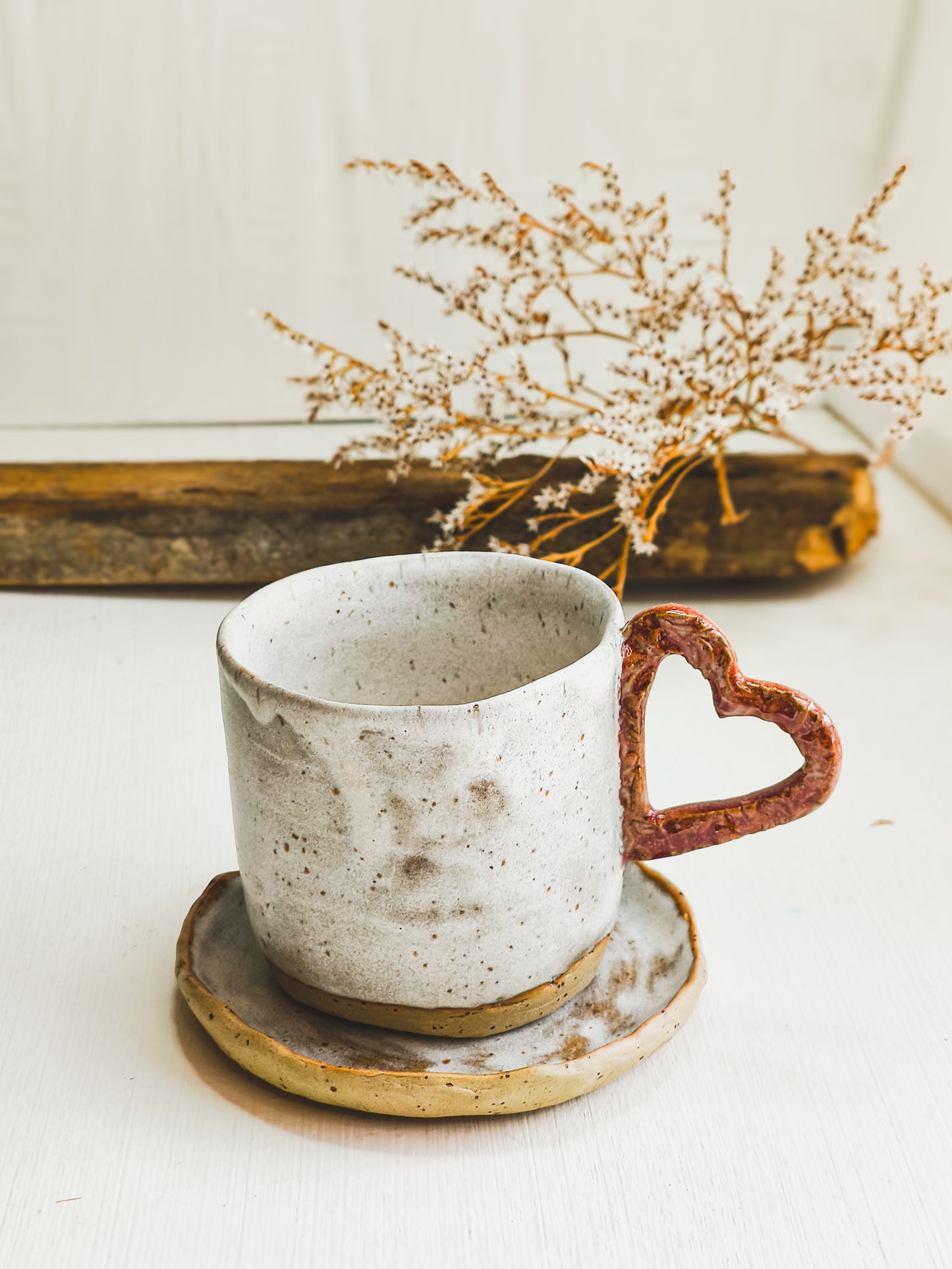 Ceramic coffee or tea mug with a heart-shaped handle